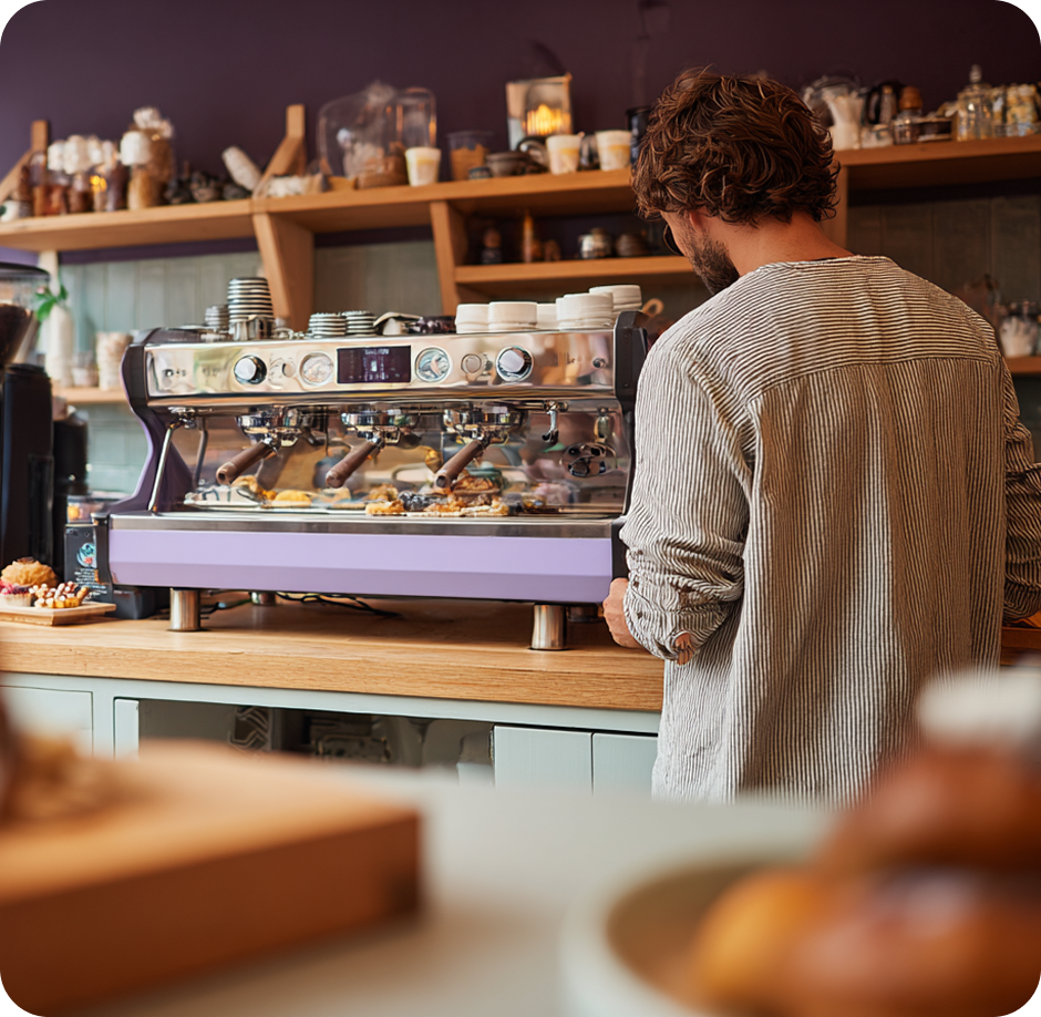 Barista working at a purple espresso machine
